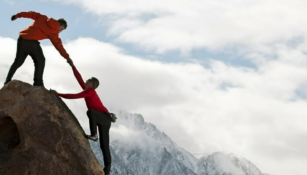 Two people mountain climbing