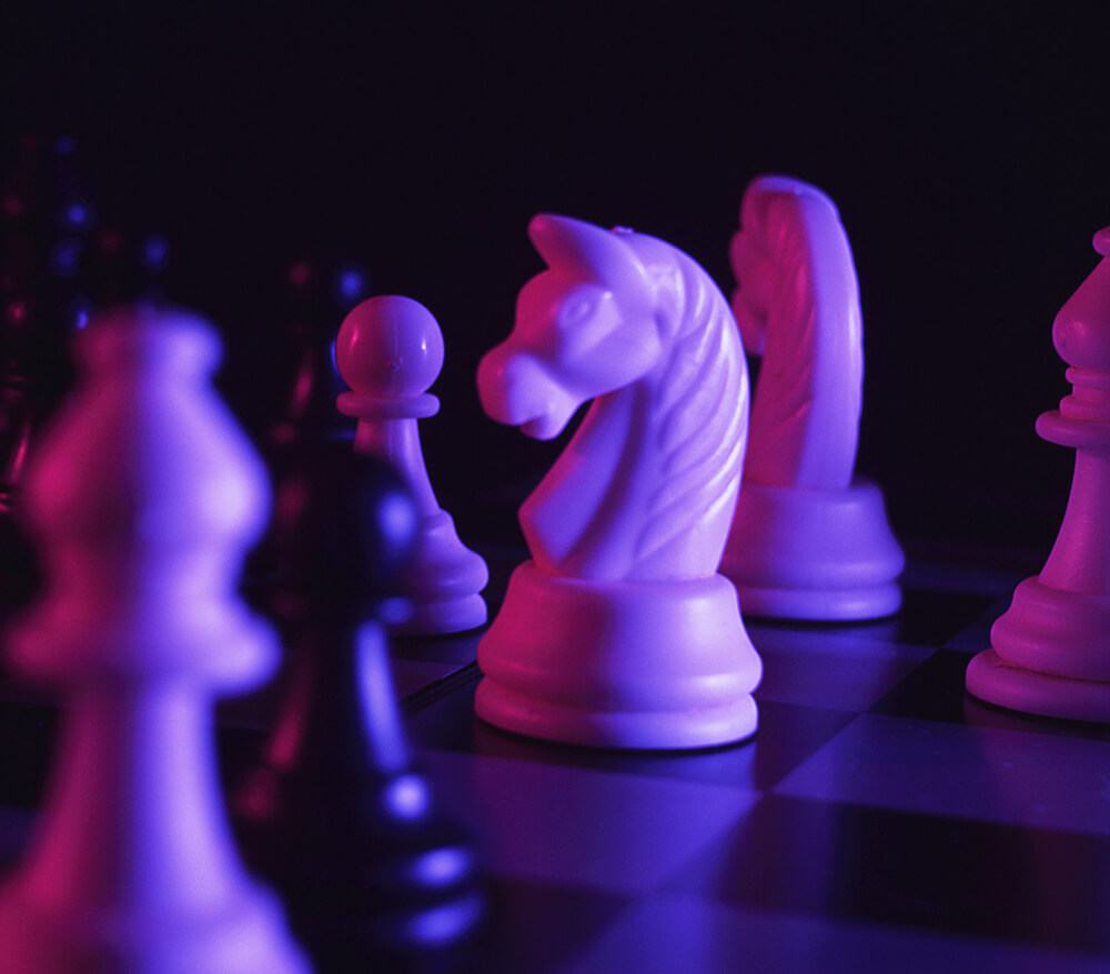 ready-strategy Close up of chess pieces in purple lighting
